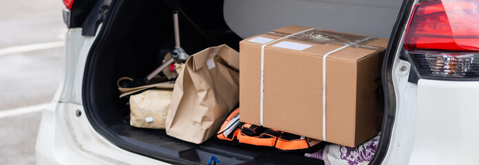 Blank paper bags in a car trunk © Angelov