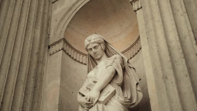 Zoom in on a Statue of a Woman holding a Lyre