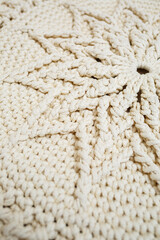 Handmade carpet knitted from natural threads, flooring, natural cotton. Beige handmade carpet. Knitted decorative item