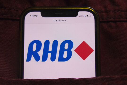KONSKIE, POLAND - February 22, 2022: RHB Bank Berhad logo on mobile phone hidden in jeans pocket