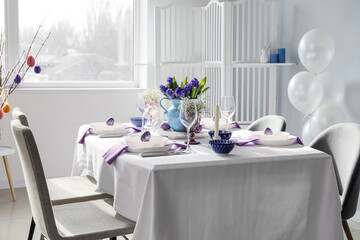 Beautiful table setting for Easter celebration in room interior