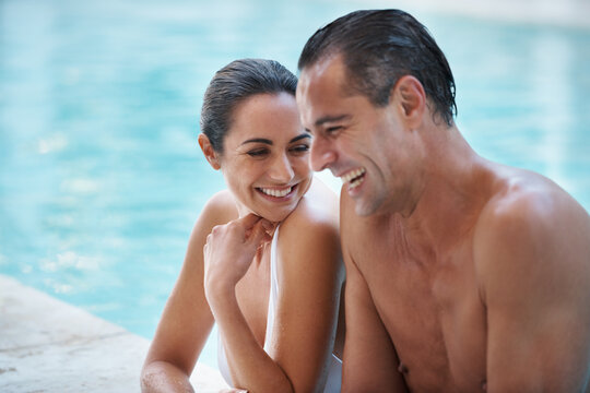 He knew how to make her laugh. Cropped shot of a loving mature couple relaxing in a pool. - Powered by Adobe
