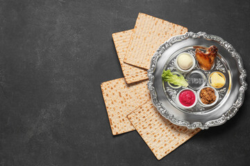 Passover Seder plate with traditional food and matza on dark background
