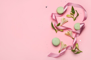 Composition with sweet macaroons, flowers and ribbon on pink background. International Women's Day celebration