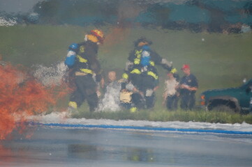 Fototapeta premium two firefighters rescuing victim in training fire