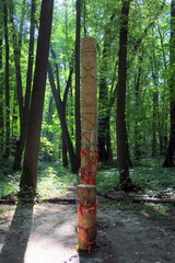 The temple of a pagan idol in the park. Statues made of wood, a temple in the forest