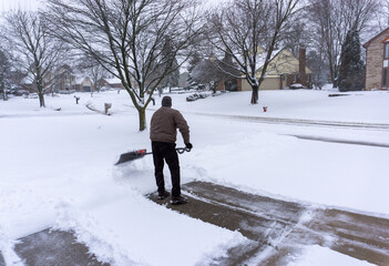Old man shoveling driveway winter storm maintenance