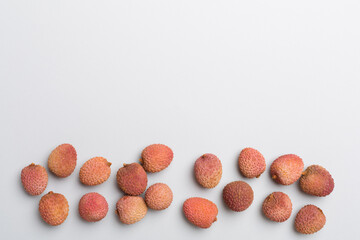 Lychee fruit on color background. Top view, flat lay