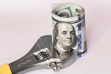 US 100 dollar banknote in adjustable wrench (spanner)