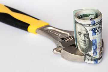 US 100 dollar banknote in adjustable wrench (spanner)