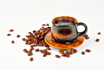 Ceramic brown coffee mug close up. Coffee isolated on a white background. Coffee beans are scattered near the drink.