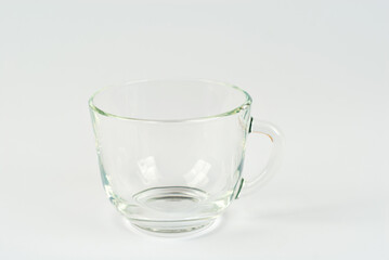 Transparent mug isolated on a white background. Tea mug close up.