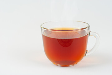 Transparent mug isolated on a white background. Mug with black tea close up.