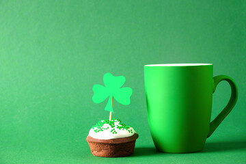 Irish coffee in green cup and special cupcakes for St Patricks Day on green background. Close up. Copy space. Happy st patricks day.