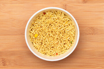 Instant Noodles in Disposable Cup on Wooden Background - Top View. Asian Fast Food. Quick Lunch