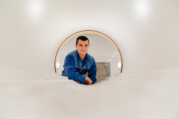 installer engineer of mri apparatus in scanner. blue uniform