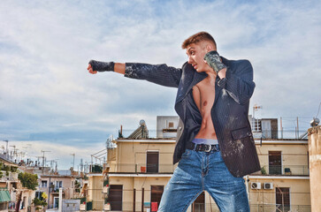 Fitness Model Fighter in Suit and Jeans doing Muay Thai Kickboxing Punch