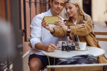 Close-up of woman holding smartphone while taking selfie