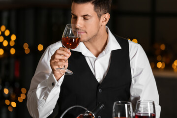 Young male sommelier tasting types of wine