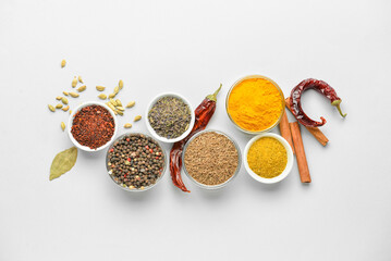 Bowls with aromatic spices on white background