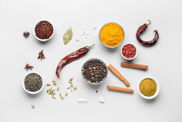 Bowls with aromatic spices on white background