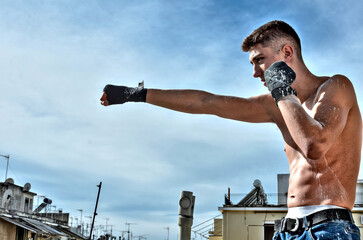 Fitness Model Fighter shirtless in Jeans doing Muay Thai Kickboxing Punch