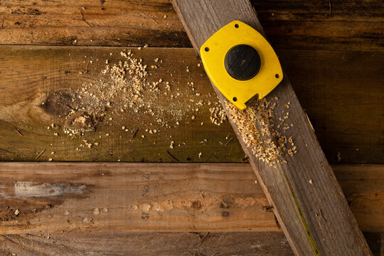Measuring Tape on top of some wood planks. 