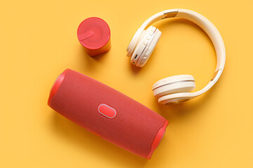 Modern wireless portable speakers and headphones on color background - obrazy, fototapety, plakaty