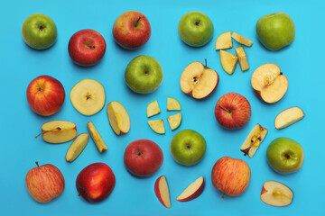 Pattern from fresh fruits red and green apples full and slices isolated on blue background. Healthy food photo.Top view /