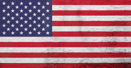 Full frame photo of a weathered flag of United States (USA, US, America) painted on a plastered brick wall.