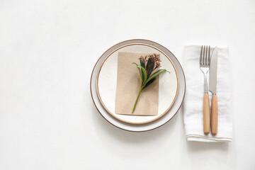Stylish simple table setting with flowers on white background