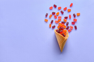 Wafer cone with sweet jelly bears on blue background