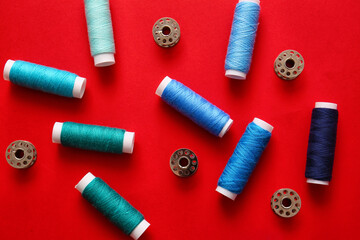 Thread spools on red background