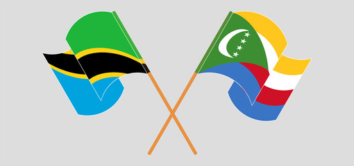 Crossed and waving flags of Tanzania and Comoros