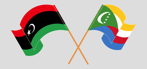 Crossed and waving flags of Libya and Comoros