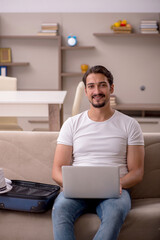 Young man preparing for trip at home