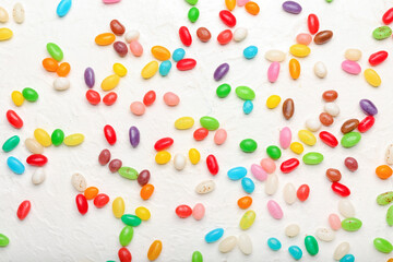 Different jelly beans on white background