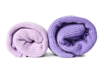 Rolled knitted lilac sweaters on white background