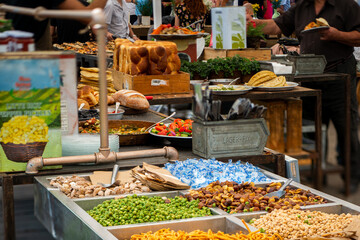 Food market event with buffet table and people eat.