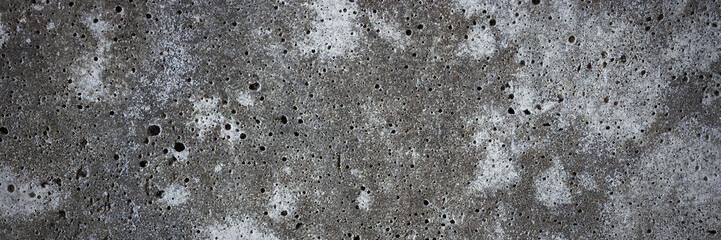 Texture of old concrete wall. Rough, stained concrete surface. Wide panoramic background for design.