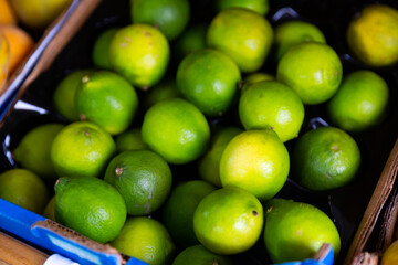 Closeup of green fresh and ripe Lime fruit at grocery store or market