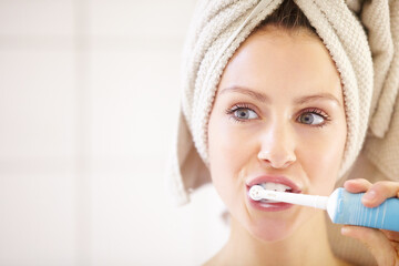 Keeping her teeth in great shape - Dental hygiene. Cropped shot of an attractive young woman brushing her teeth.
