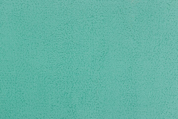 Green aquamarine turquoise azure plaster wall abstract pattern texture coarse surface background rough stucco