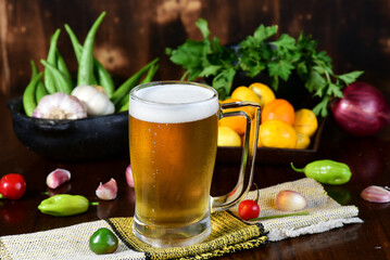 pequi fruit typical Brazilian food, okra spices, salad and melted cheese au gratin with choop mug on blurred background