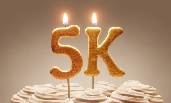 Milestone cake celebrating 5000 followers or subscribers. Golden ‘5k’ number candles on cake with icing in neutral tones. 3D rendering