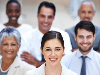 Fototapeta premium I lead by example. Portrait of a smiling businesswoman surrounded by a group of her colleagues.