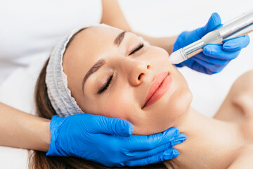 Beautiful woman receiving microneedling rejuvenation treatment. Mesotherapy.