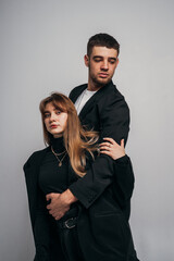 Gymnastic support. Woman and man in black suits, acrobatic exercise