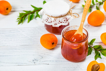 Apricot Jam with Fresh Summer Apricot on White Wooden Background. Selective focus.