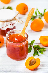 Apricot Jam with Fresh Summer Apricot on White Wooden Background. Selective focus.